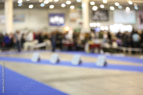 Interior of room prepared for dog show, blurred view photo