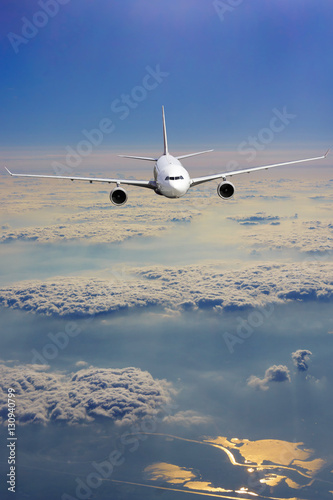 airliner flying above clouds. Passenger airplane