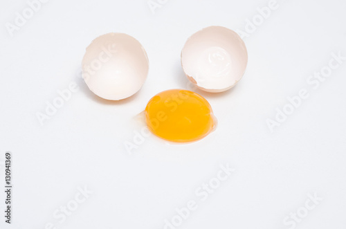Eggs chicken bird with egg yolk and shell on a gray background