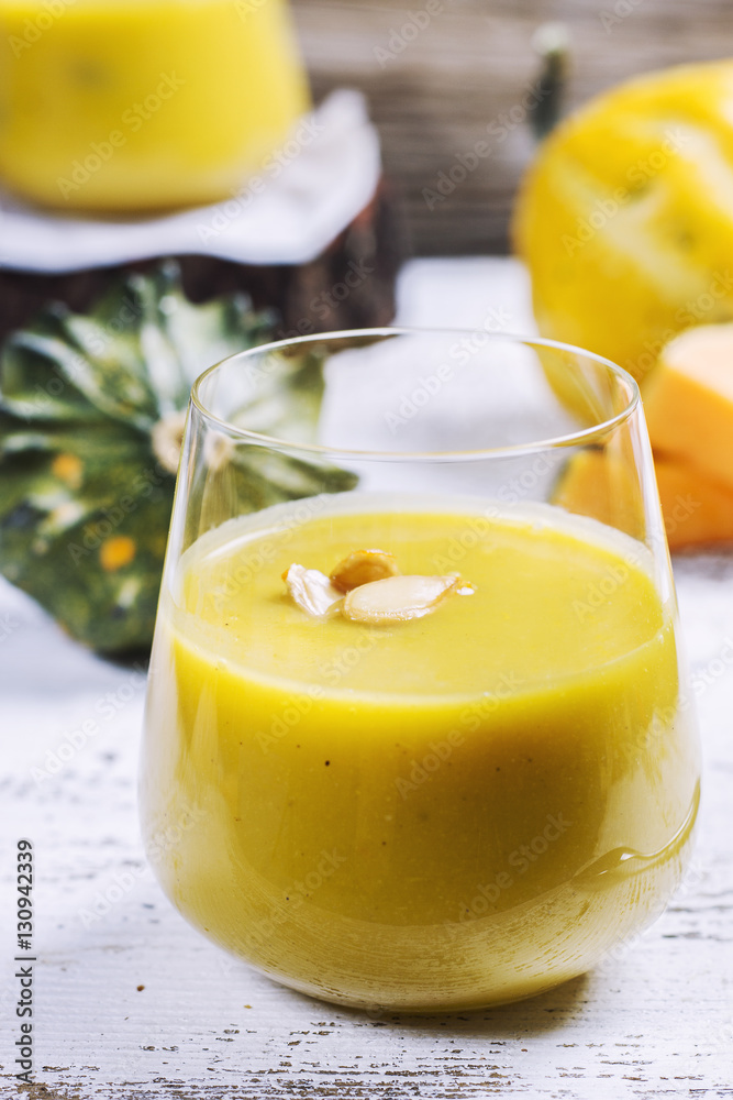 pumpkin soup in a glass on a wooden rustic table pumpkin soup in a glass on a wooden rustic table