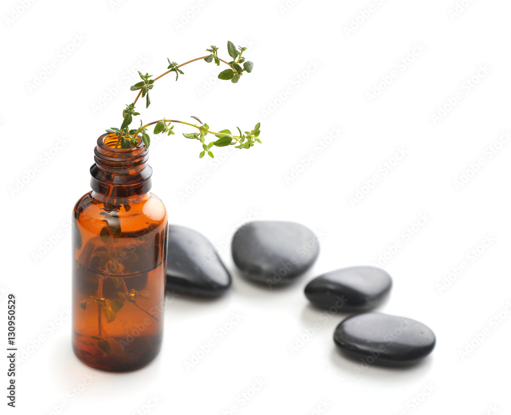 Bottle of essential oil with herbs thyme Bottle of essential oil with herbs thyme
