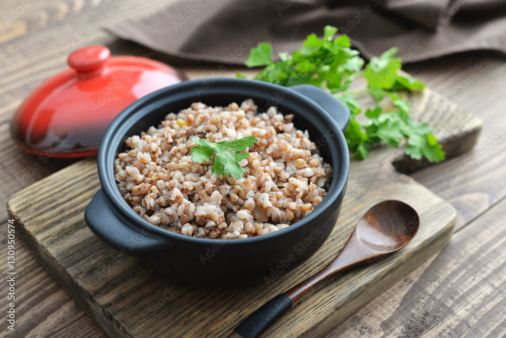 Buckwheat porridge in black casserole Buckwheat porridge in black casserole