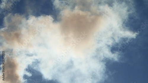 white smoke against a blue cloud sky sunlight landscape nature