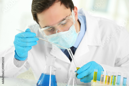 Young male scientist making...