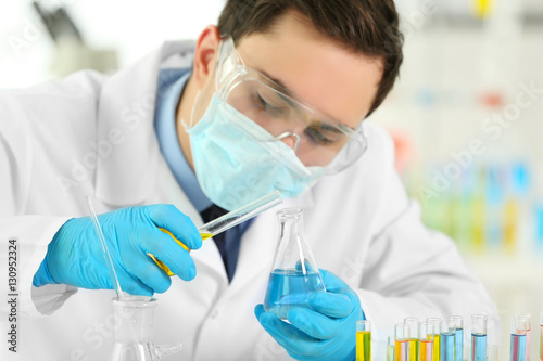 Young male scientist making...
