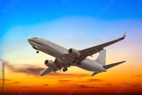 Commercial airplane flying with beautiful sunset background
