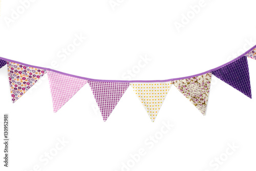 Cute garland of colored flags. Decorations of colorful pennants. Purple, cotton fabric party flags.