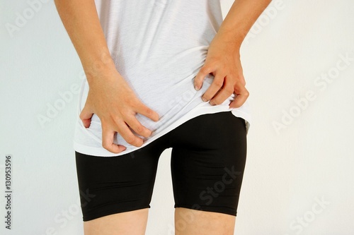 Young woman has itching the buttocks, Healthcare concept.