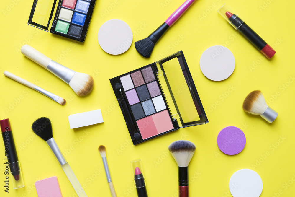 Set of colorful cosmetics on yellow background Set of colorful cosmetics on yellow background