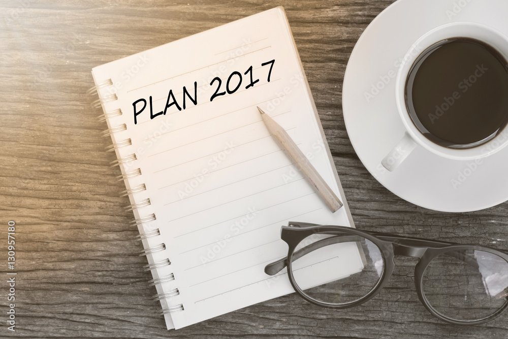 Plakat Plan 2017 On notebook with coffee cup, glasses and pencil on woo