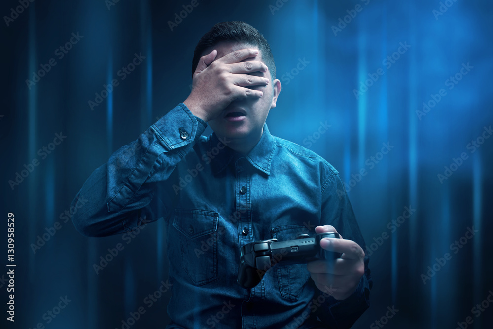 Young man losing playing video game Young man losing playing video game