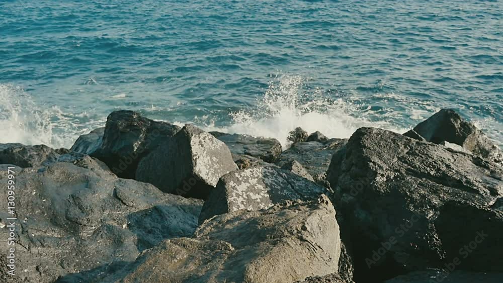 Ocean waves crashing on stone beach Ocean waves crashing on stone beach