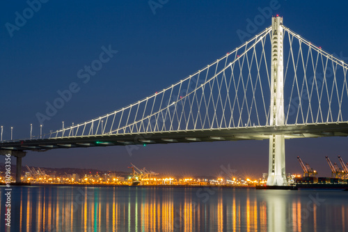 The New San Francisco's Bay Bridge East Wing at Night with Port of Oakland reflections. Taken from Treasure Island, California, USA.