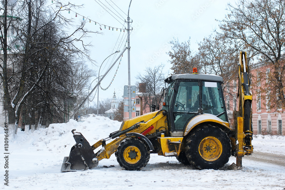 tractor for snow removal is parked on a city street tractor for snow removal is parked on a city street