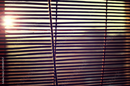 the sun is shining through the blinds