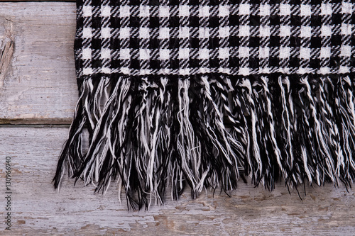 Detail of warm checkered scarf with fringe.