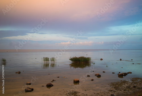 the pink sky is reflected Ladoga lake in the evening