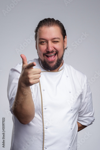 Pleased chef laughs and shows thumbs up. Approval of the selection