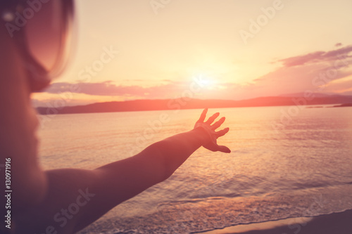 Girl enjoying free with ocean / sea background. © astrosystem