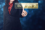 Business woman hand touching 2017 in search bar