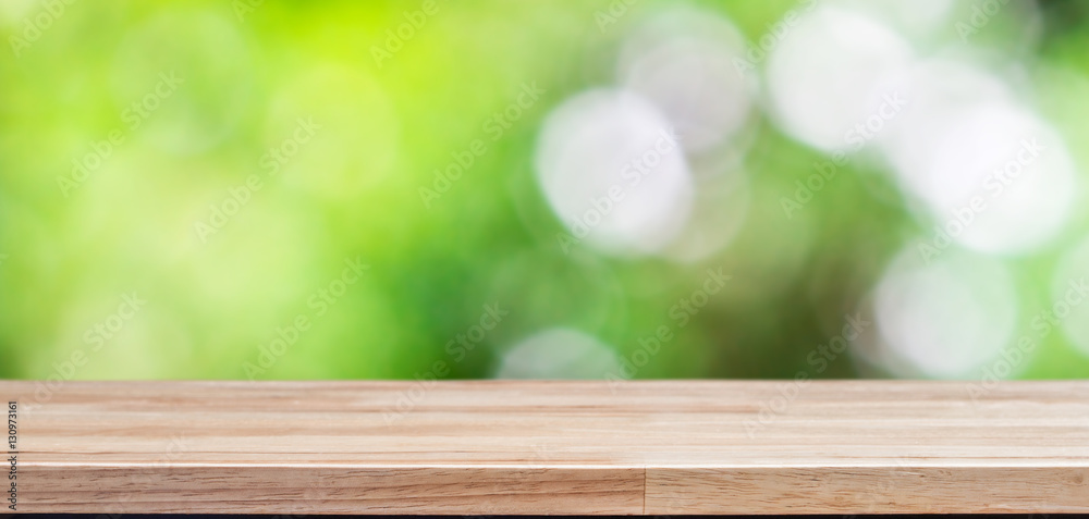 Wood table top on bokeh green background Wood table top on bokeh green background