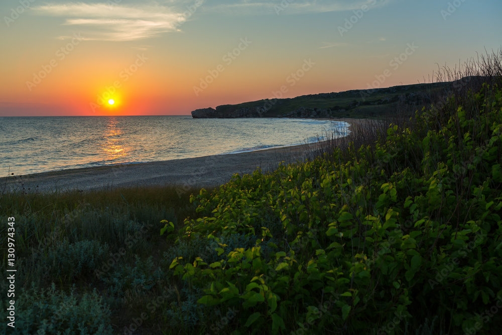 Sun rises over the Sea of Azov on Generals beach. Karalar regional landscape park in Crimea.