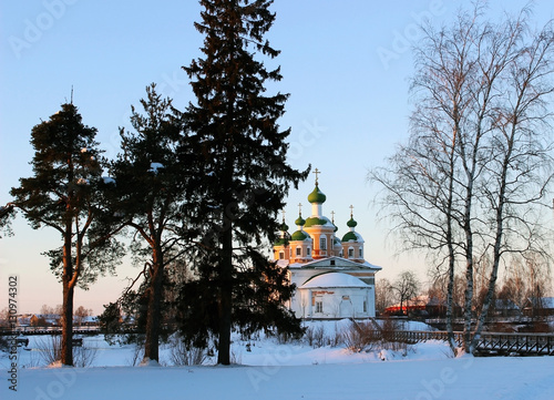 Olonets, Karelia, view of the town park and orthodox church in winter sunset photo
