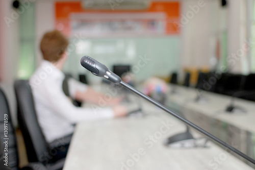 Microphone soft focus on blur abstract background lecture hall/ seminar meeting room in business event/ educational academic classroom training course: Speaker / teacher's mic in college class room