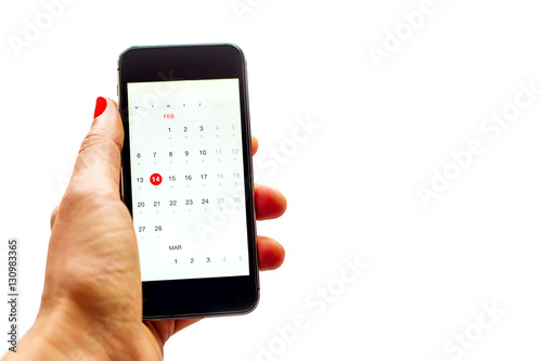 Woman hand with telephone, calendar at valentine's Day date. Isolated.