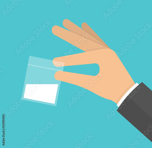 Hand holding plastic bag filled with white powder