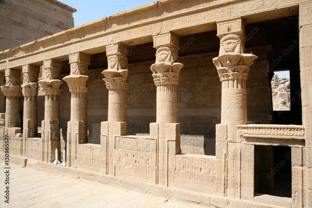 stone carved colonnade in wall of landmark Philae Temple, Egyptian public monument for the goddess Isis, declared World Heritage Unesco, in Egypt, Africa

