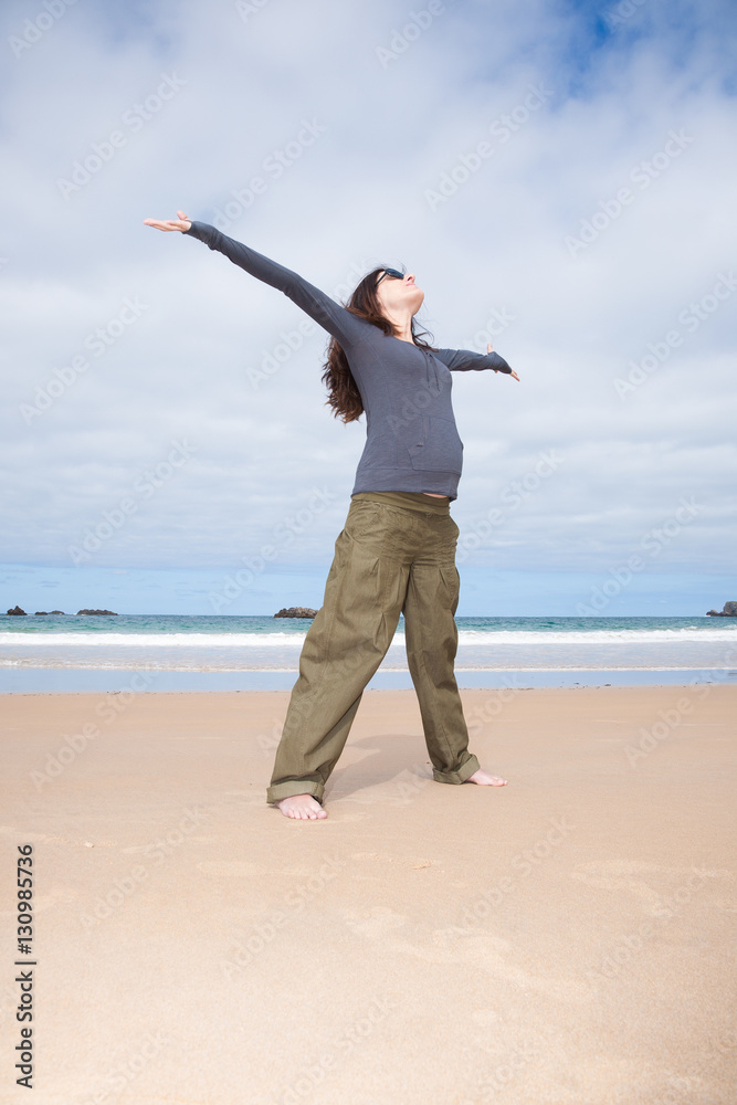 brunette brown hair pregnant woman with grey shirt green trousers and black sunglasses happy joyful open arms in sand beach ocean in Asturias Spain
brunette brown hair pregnant woman with grey shirt green trousers and black sunglasses happy joyful open arms in sand beach ocean in Asturias Spain