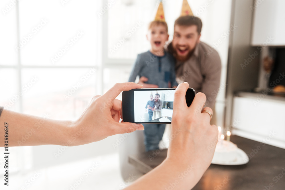 Smiling bearded father with his birthday little son making selfie