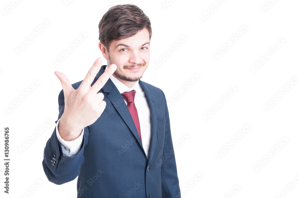 Smiling sales man showing three with one hand Smiling sales man showing three with one hand