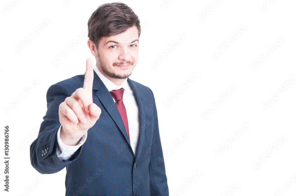 Smiling man wearing suit showing number one Smiling man wearing suit showing number one