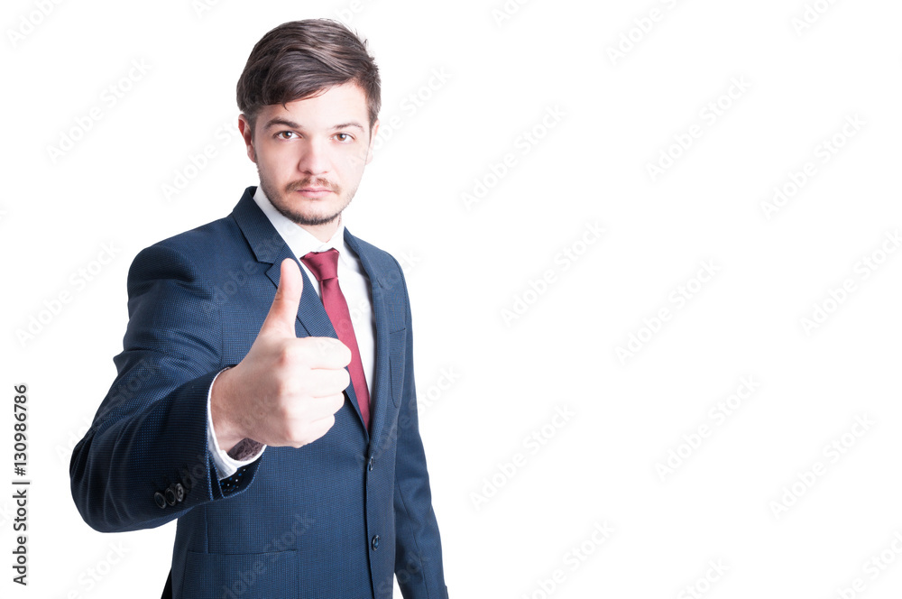 Sales man wearing suit making thumb up gesture Sales man wearing suit making thumb up gesture