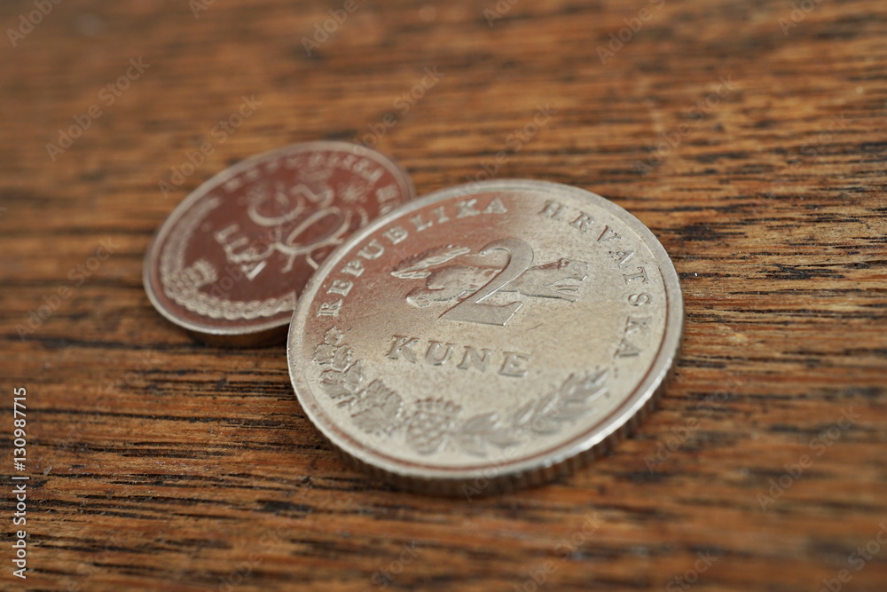 Macro detail of Croatian coins (Kuna and Lipa, HRK) on the wooden desk as a financial background of currency used in Croatia Macro detail of Croatian coins (Kuna and Lipa, HRK) on the wooden desk as a financial background of currency used in Croatia