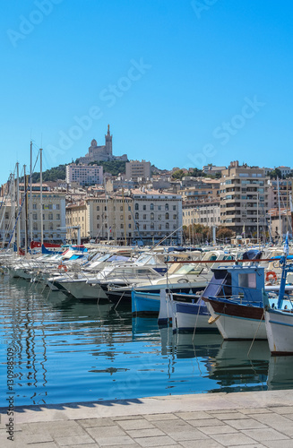 Yachts in the port of Marseilles on the background of the church of Notre Dame de la Garde