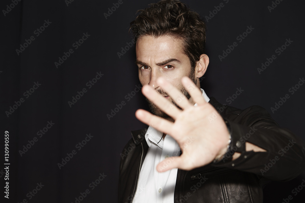 Man blocking photograph being taken, portrait Man blocking photograph being taken, portrait