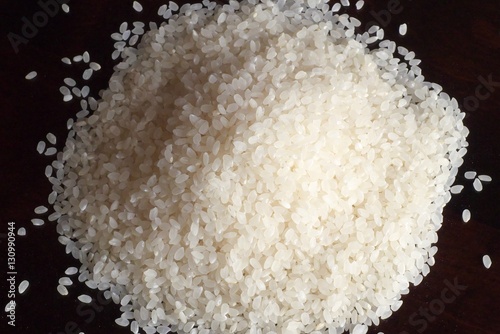 White rice on wood background