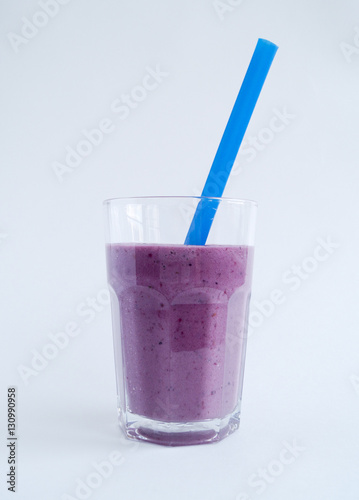 BlackBerry Smoothie in a glass beaker on a white background with purple tubes