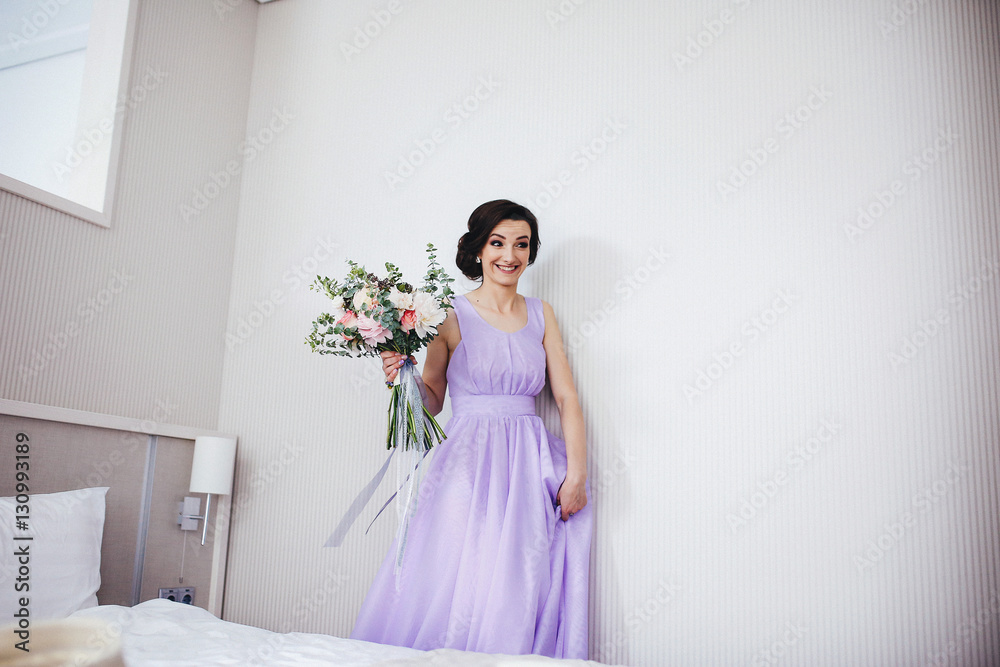 The bridesmaid keeps a wedding bouquet The bridesmaid keeps a wedding bouquet