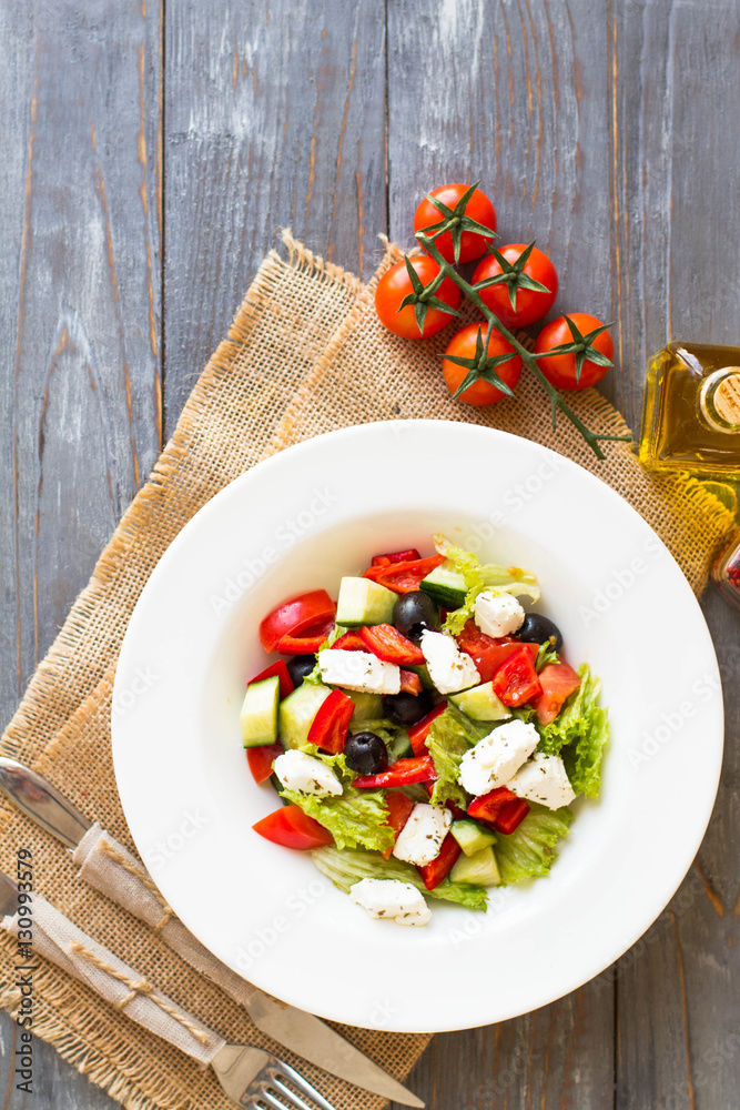 Greek salad with fresh vegetables, feta cheese and black olives. Top view