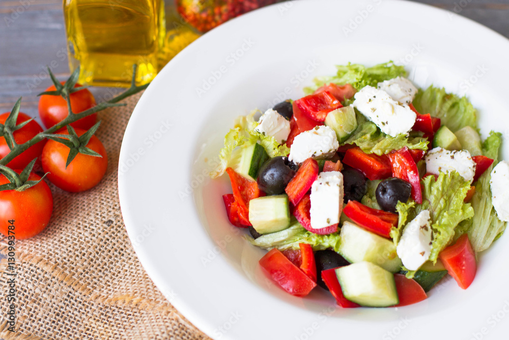 Greek salad with fresh vegetables, feta cheese and black olives. Top view Greek salad with fresh vegetables, feta cheese and black olives. Top view