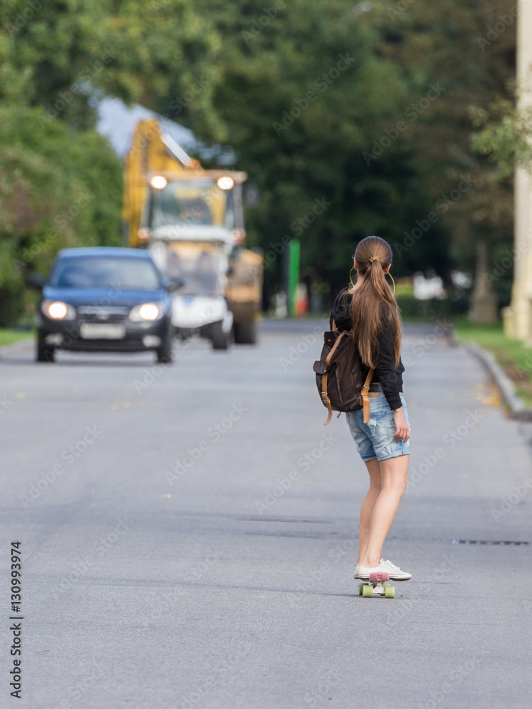 Unrecognizable girl rides a skateboard Unrecognizable girl rides a skateboard