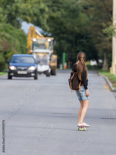 Unrecognizable girl rides a skateboard