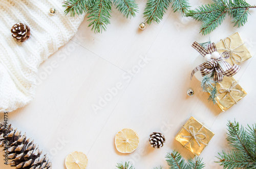 Christmas gifts, fir branches and pine cones flat lay background.