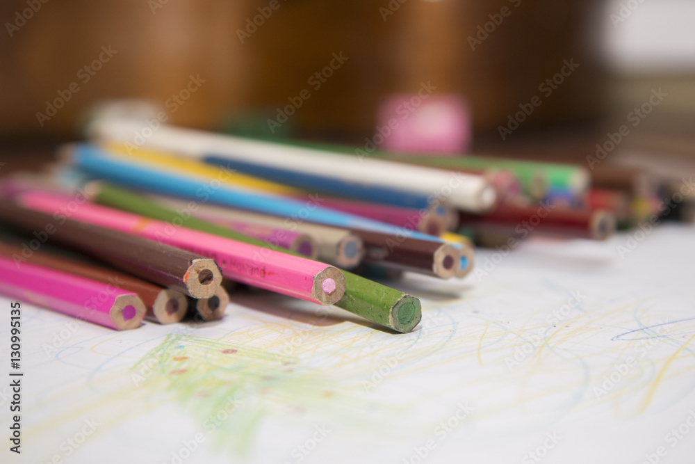Lot of color pencils and a sheet of white paper. Lot of color pencils and a sheet of white paper.