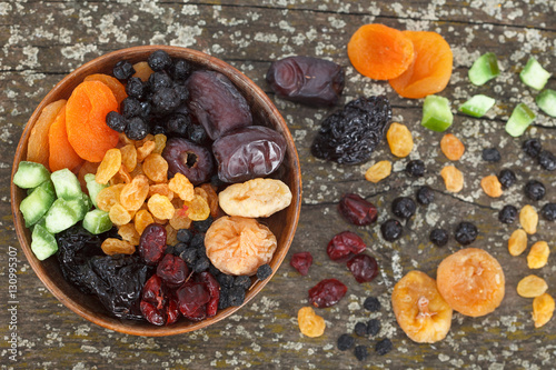 Mix of dried fruits on a dark wood background. Top view. © meteo021
