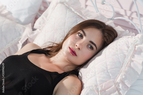 Young woman cant got sleeping in bed closeup. Beautiful lady lying on pillow with opened eyes, thinking about something. Insomnia, worry, fear concept